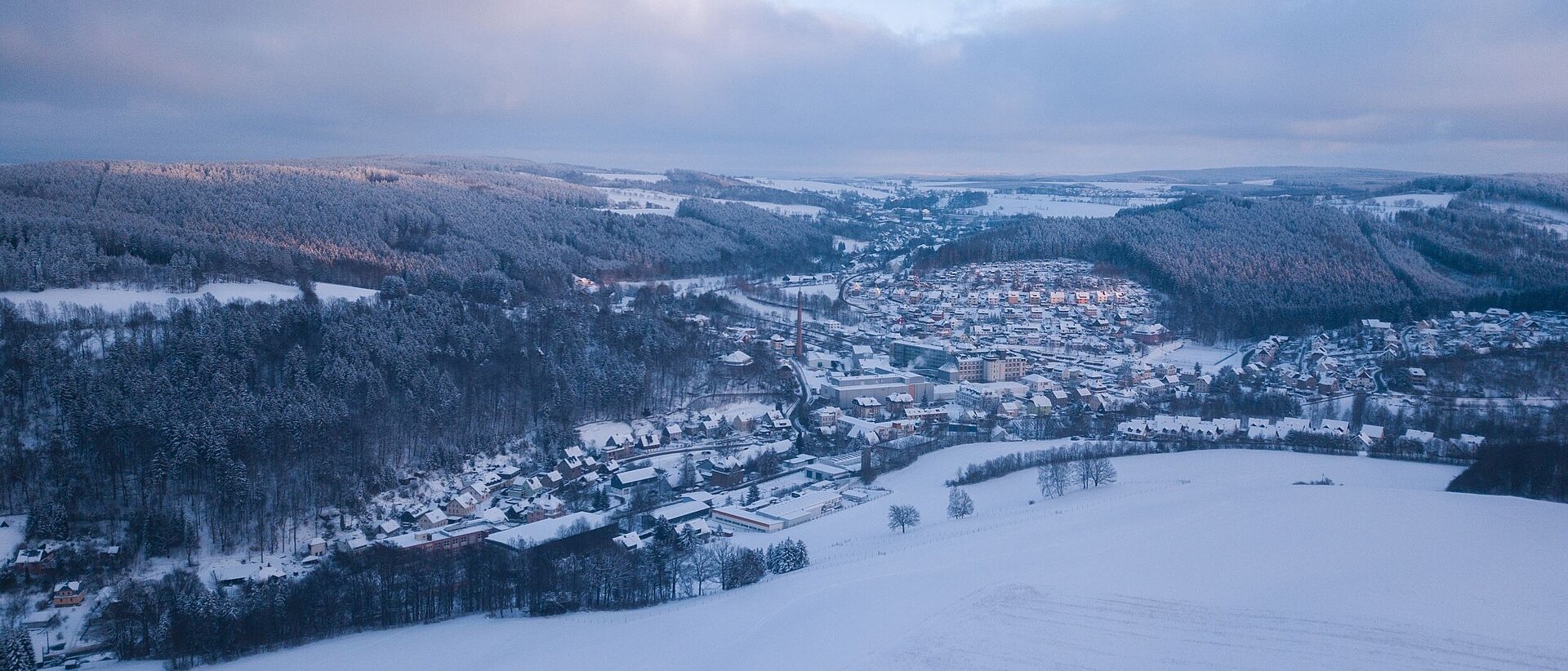 Das Erzgebirges im Winter. Gornsdorf, mit seinen Häusern und Gebäuden, sowie die umliegenden Berge und Wälder sind mit Schnee überzogen.