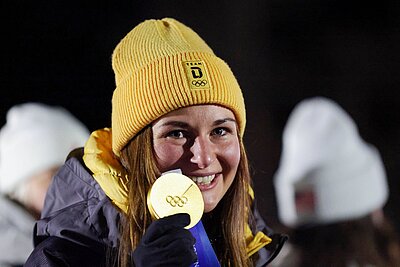 Julia Taubitz ist &uuml;bergl&uuml;cklich: Sie h&auml;lt ihre erste olympische Gold-Medaille in der Hand. Die Rennrodlerin und Botschafterin des Erzgebirges holte am 10. Februar 2026 den Sieg im Eiskanal von Cortina d&rsquo;Ampezzo.